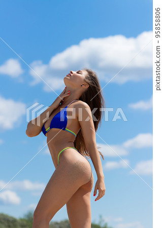 Charming woman in bikini on beach 95858806