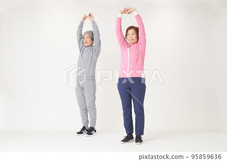 Two senior women stretching Two senior women stretching 95859636