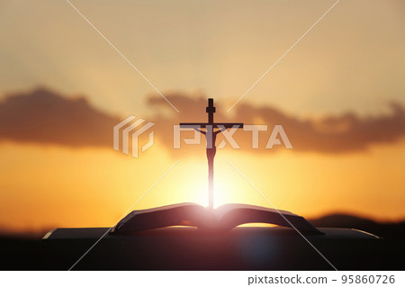 The sunset sky and clouds shining red like blood and the cross symbolizing the death and resurrection of Jesus Christ The sunset sky and clouds shining red like blood and the cross symbolizing the death and resurrection of Jesus Christ 95860726