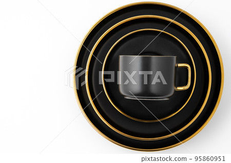 A set of black and golden ceramic plates and cup on a white background. Top view A set of black and golden ceramic plates and cup on a white background. Top view 95860951