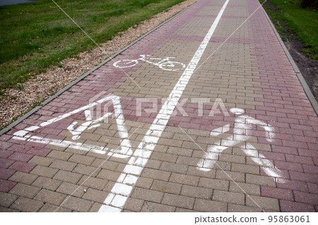 Bicycle path sign on paving slabs closeup Bicycle path sign on paving slabs closeup 95863061
