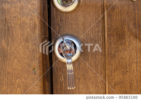 Key in the lock on the wooden door 95863100