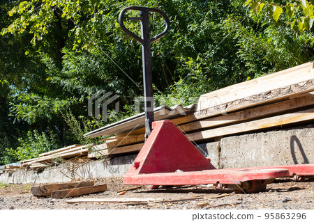 Red forklift cart at the sawmill in the yard Red forklift cart at the sawmill in the yard 95863296