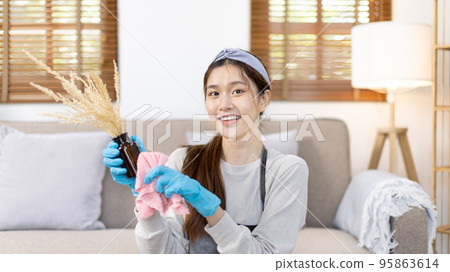 Beautiful housewife is cleaning things and vases in the living room, Big cleaning, Housework, Daily routine ,Removes germs and dirt and deep stains, Spray alcohol, Clean up on weekends. Beautiful housewife is cleaning things and vases in the living room, Big cleaning, Housework, Daily routine ,Removes germs and dirt and deep stains, Spray alcohol, Clean up on weekends. 95863614