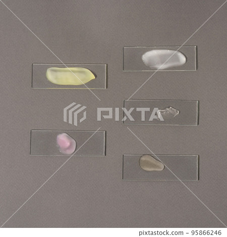 Smears of cosmetic products for the face on laboratory glass Smears of cosmetic products for the face on laboratory glass 95866246