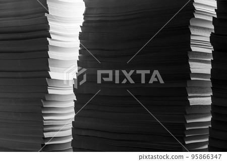 Illuminated stacks of white paper Illuminated stacks of white paper 95866347