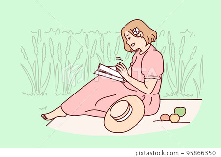 Woman sitting in field reading book 95866350