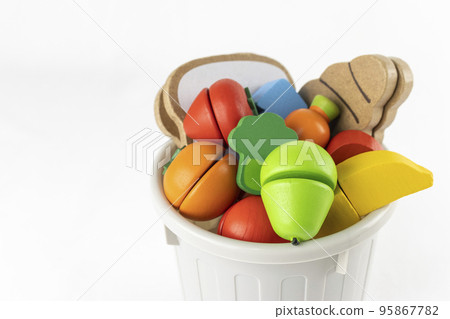 Wooden toy food and trash. image of food loss Wooden toy food and trash. image of food loss 95867782
