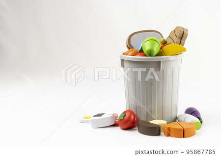 Wooden toy food and trash. image of food loss Wooden toy food and trash. image of food loss 95867785