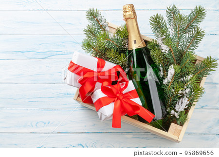 Christmas gift box with champagne bottle Christmas gift box with champagne bottle 95869656