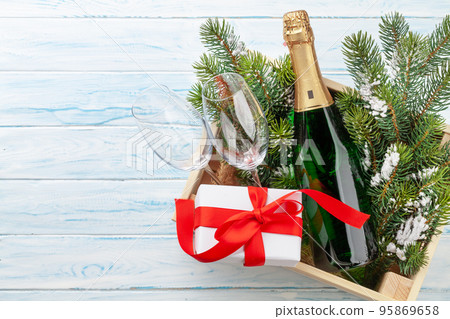 Christmas gift box with champagne bottle Christmas gift box with champagne bottle 95869658