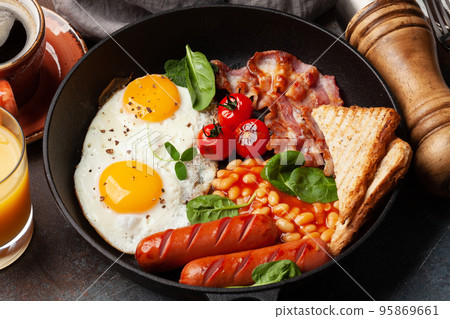 English breakfast with fried eggs, beans, bacon and sausages English breakfast with fried eggs, beans, bacon and sausages 95869661