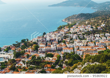 View of the panorama of the Turkish city of Kas from above. Tourist attractions of Turkey and Mediterranean Sea. Travel, vacation, tourism concept. View of the panorama of the Turkish city of Kas from above. Tourist attractions of Turkey and Mediterranean Sea. Travel, vacation, tourism concept. 95869922