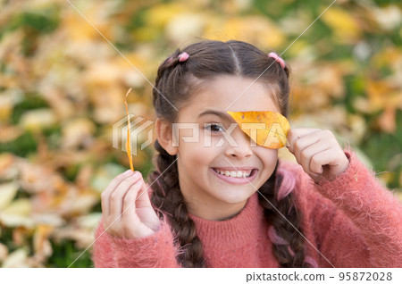 Happy childhood. School time. Small child with autumn leaves. Happy little girl in autumn forest. Autumn leaves and nature. Feeling free and relaxed. Happy to be around. Trendy beauty Happy childhood. School time. Small child with autumn leaves. Happy little girl in autumn forest. Autumn leaves and nature. Feeling free and relaxed. Happy to be around. Trendy beauty 95872028