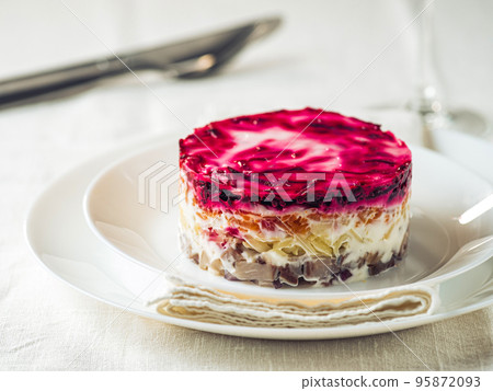 Salad herring under fur coat on festive plate 95872093