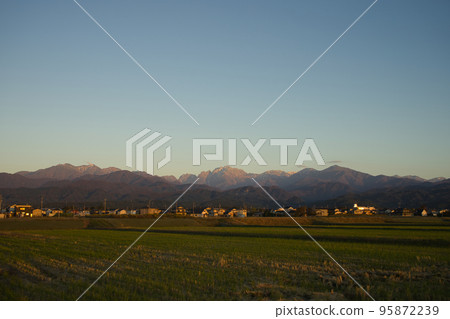 The Northern Alps, Tateyama Mountain Range, Mt. Tsurugi seen from Kamiichi Town, Toyama Prefecture on an autumn evening The Northern Alps, Tateyama Mountain Range, Mt. Tsurugi seen from Kamiichi Town, Toyama Prefecture on an autumn evening 95872239