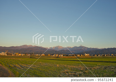 The Northern Alps, Tateyama Mountain Range, Mt. Tsurugi seen from Kamiichi Town, Toyama Prefecture on an autumn evening 95872241