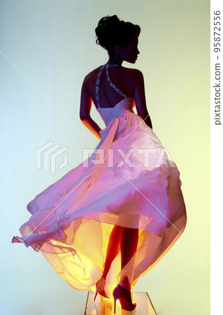 Beautiful young lady posing in a photo studio in a chic dress. S Beautiful young lady posing in a photo studio in a chic dress. S 95872556