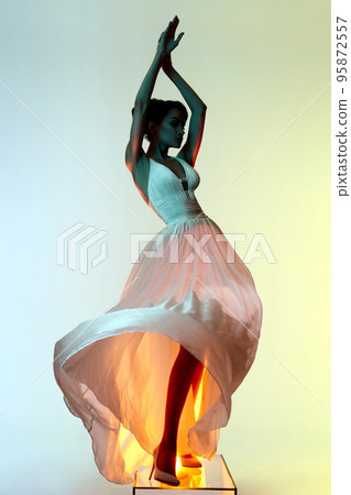 Beautiful young lady posing in a photo studio in a chic dress. S Beautiful young lady posing in a photo studio in a chic dress. S 95872557