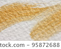 Abstract background of golden brush strokes on watercolor paper 95872688