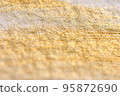 Close up of watercolor paper with gold paint 95872690