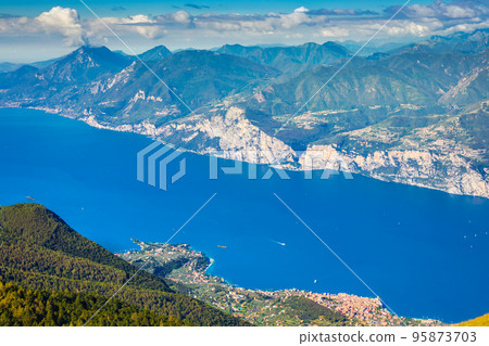 Above idyllic and turquoise Lake Garda from Monte Baldo, Malcesine, Italy 95873703