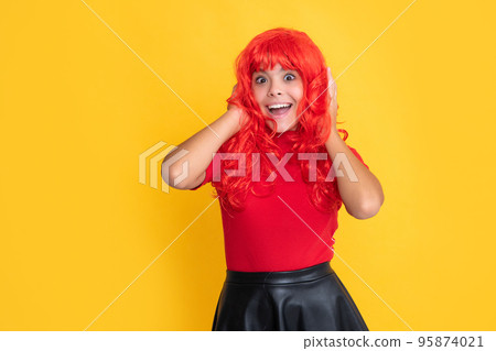 surprised kid with red long hair on yellow background 95874021
