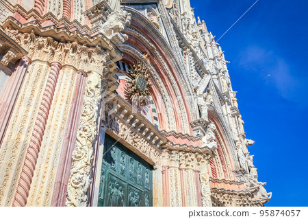 Medieval ancient and ornate cathedral at clear sky, Tuscany, Italy 95874057