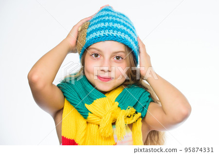 Warm woolen accessories. Girl long hair happy face white background. Which fabrics will keep you warmest this winter. Hat and scarf keep warm. Kid wear warm soft knitted blue hat and long scarf Warm woolen accessories. Girl long hair happy face white background. Which fabrics will keep you warmest this winter. Hat and scarf keep warm. Kid wear warm soft knitted blue hat and long scarf 95874331