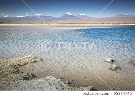 Volcanic landscape and salt lake reflection at sunset in Atacama Desert, Chile 95874740