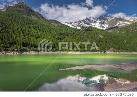 Alpine lake and dramatic landscape at springtime, Gran Paradiso alps , Italy Alpine lake and dramatic landscape at springtime, Gran Paradiso alps , Italy 95875186