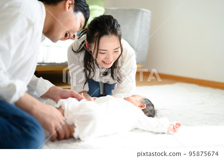 Asian mother and father soothing a baby Copy space on the right Asian mother and father soothing a baby Copy space on the right 95875674