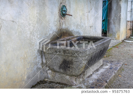 Rustic well with running water from fountain in Innsbruck, Tyrol, Austria Rustic well with running water from fountain in Innsbruck, Tyrol, Austria 95875763