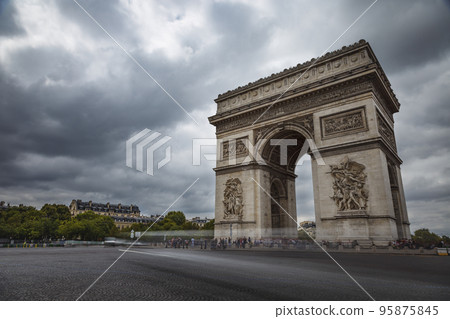 Arc de Triomphe at dramatic sky with storm clouds and blurred car, Paris, France Arc de Triomphe at dramatic sky with storm clouds and blurred car, Paris, France 95875845