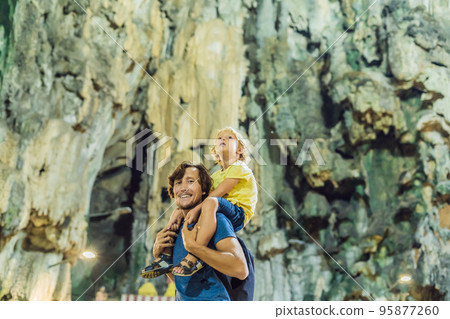 Father and son in the background of Batu Caves, near Kuala Lumpur, Malaysia. Traveling with children concept 95877260