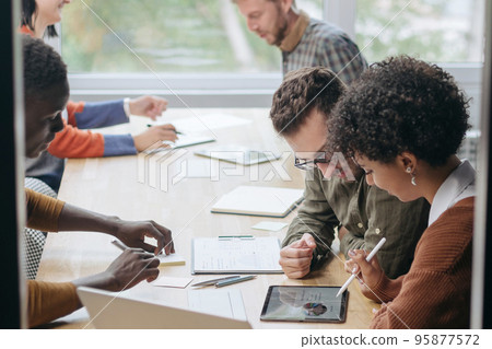 multinational business team works in a modern hall of the cowork 95877572