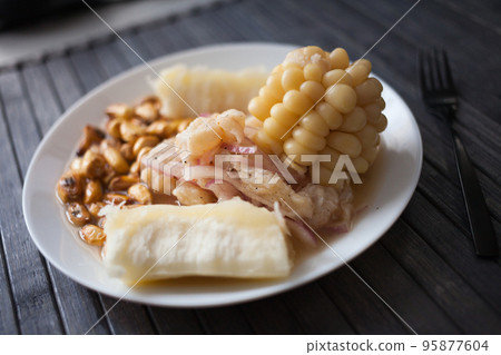 Peruvian traditional dish.fish ceviche with yuka and corn 95877604