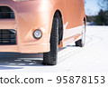 A light vehicle parked on a snowy road 95878153