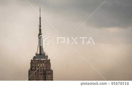 Vintage view of a skyscraper tower in a light haze of fog or smog 95878518