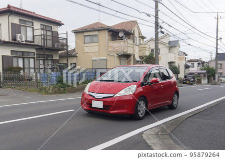 Compact car road driving Compact car road driving 95879264