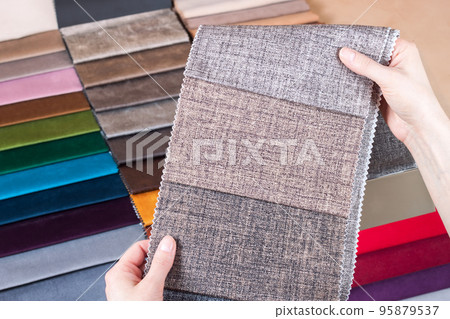 Woman chooses samples of colored tissue Woman chooses samples of colored tissue 95879537