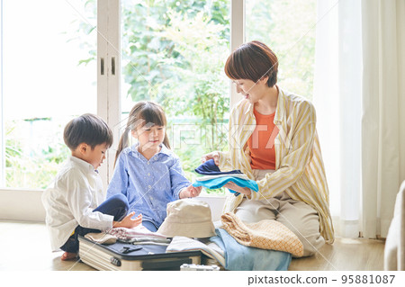 Mother and children preparing for a trip Mother and children preparing for a trip 95881087