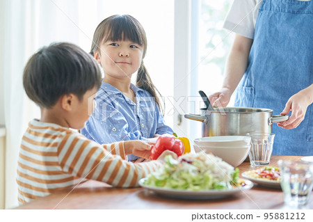 Children helping prepare meals 95881212