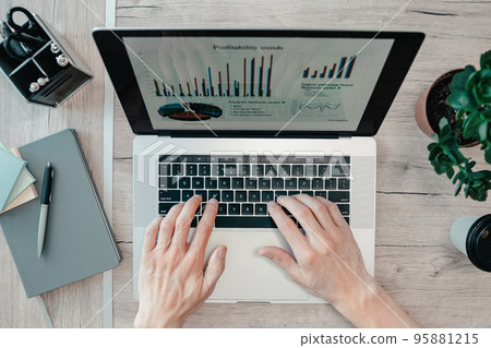 top view. man using a laptop to analyze financial data. top view. man using a laptop to analyze financial data. 95881215
