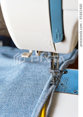 sewing machine. the process of sewing a decorative cord of blue fabric. sewing machine. the process of sewing a decorative cord of blue fabric. 95881480