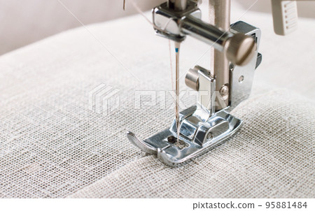 Close-up of modern sewing machine presser foot and needle Close-up of modern sewing machine presser foot and needle 95881484