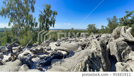 sandstone rocks with a view with trees and blue sky 95881911