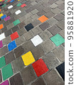 coloured tiles on a pavement in a downfacing perspective 95881920