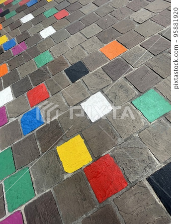 coloured tiles on a pavement in a downfacing perspective coloured tiles on a pavement in a downfacing perspective 95881920