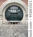 round door from the Middle Ages in a wall 95881921